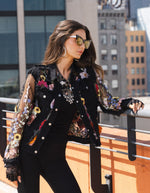 Front image of Adore black multi embroidered denim frayed edge jacket. 