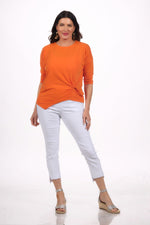 Front image of orange knot top.