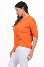 Side image of orange knot top.