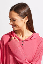 Front image of hot pink long sleeve top with kangaroo pocket. 