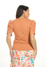 Back image of democracy light orange ruched detail top. 