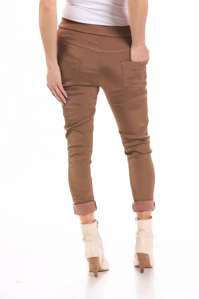 Back image of Gigi Moda pull on stain pants in rust brown. 